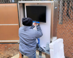 Installing Law Enforcement Monitor at Campus Entrance. Certified Fiber/Copper Install, Design/Build.
